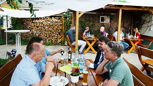Gäste sitzen am Tisch und reden