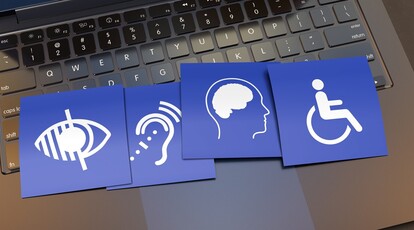 Symbolbild: Digitale Barrierefreiheit. Kärtchen mit unterschiedlichen Symbole für Einschränkungen liegen auf der Tastatur von einem Laptop
