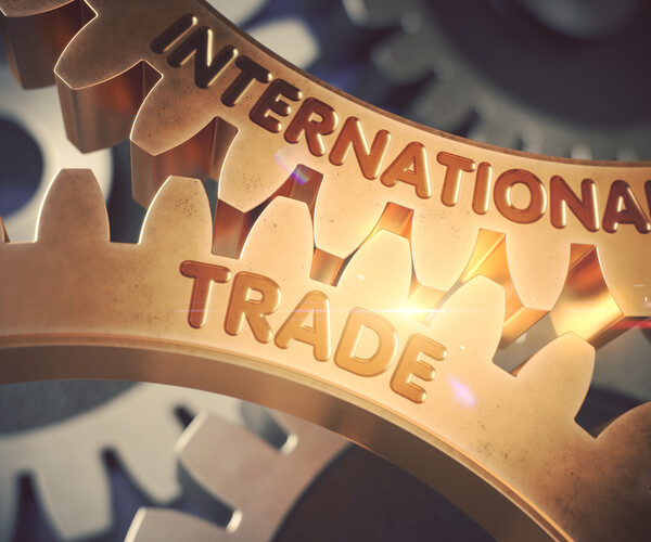 Zwei ineinandergreifende Zahnräder mit den Wörtern International und Trade.