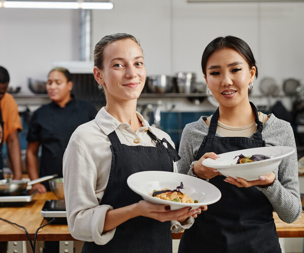 Waitresses Holding Gourmet Dishes