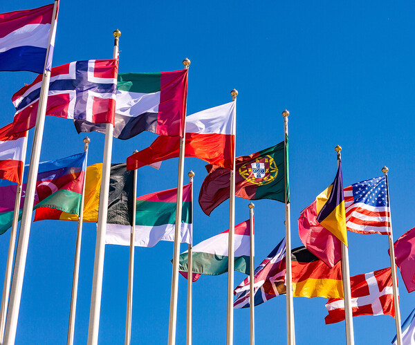 Flags of different countries flutters in the wind against
