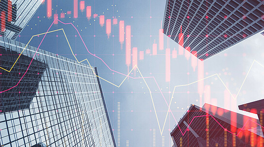 Investing, trading and real estate market crisis concept with digital red financial chart candlestick and graphs on modern skyscraper tops bottom view background, double exposure
