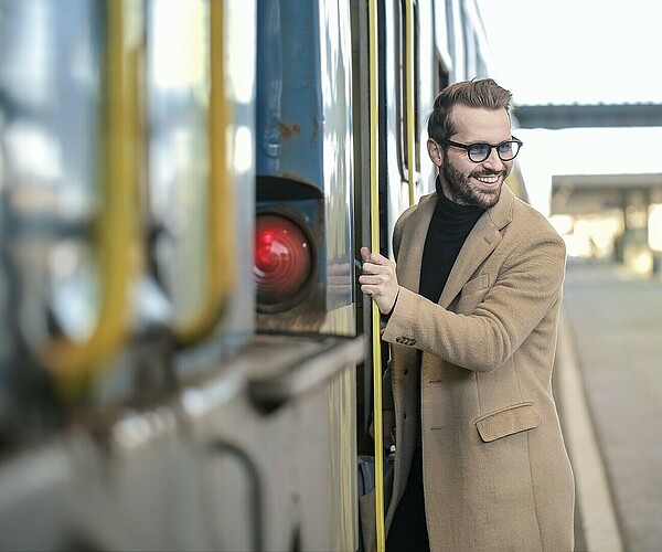 Mann steigt in Zug ein