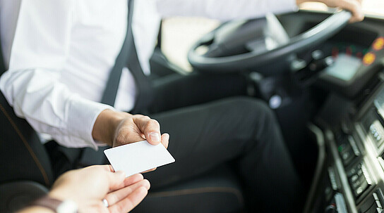 Bus Driver Accepting Ticket From Tourist