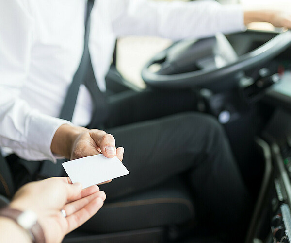 Bus Driver Accepting Ticket From Tourist