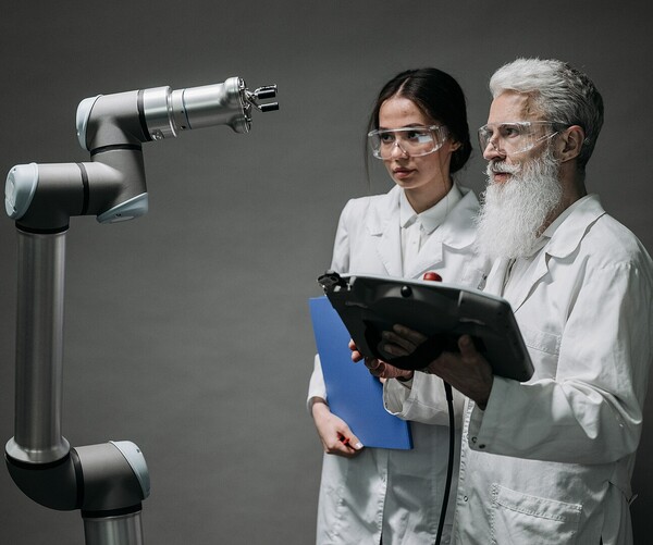 zwei Laborarbeiter schauen Laborgerät an