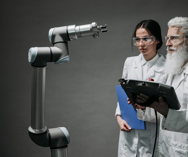 zwei Laborarbeiter schauen Laborgerät an